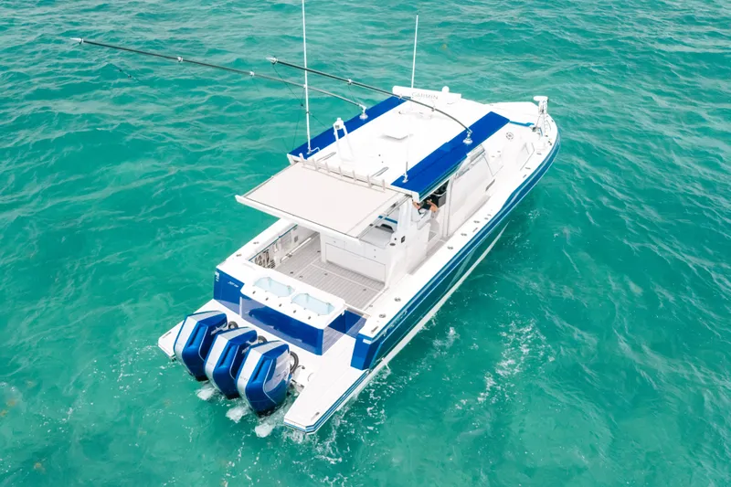 Slide: The Image of 2026 Formula 387 Center Console Fish boat cruising on turquoise water. - 4