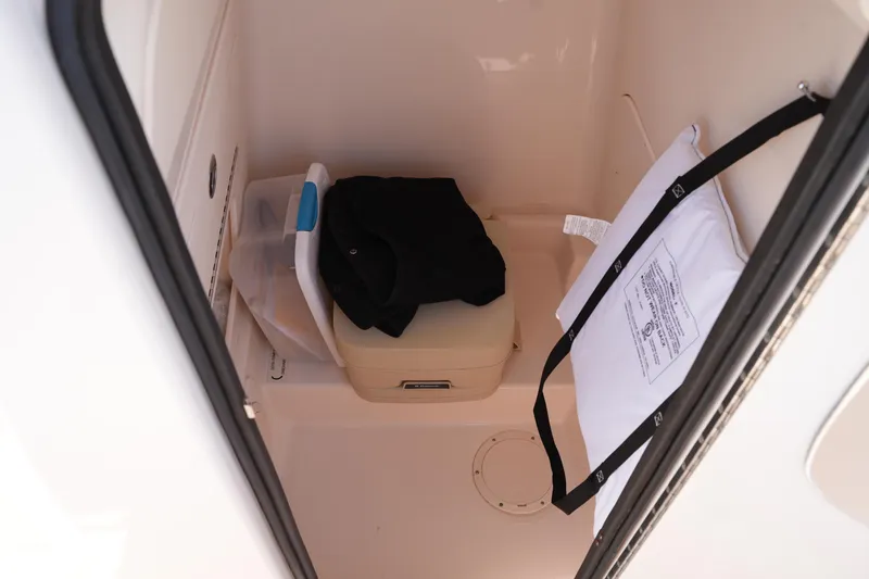 Slide: The Image of Interior storage compartment of 2017 Grady-White Fisherman 236 boat with life jacket and gear. - 26