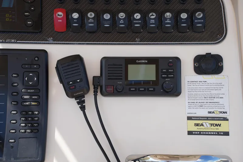 Slide: The Image of Control panel of a 2017 Grady-White Fisherman 236 with Garmin marine radio and Sea Tow information. - 22