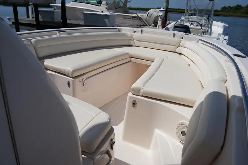 Slide: The Image of 2017 Grady-White Fisherman 236 boat interior with cushioned seating and storage. - 27