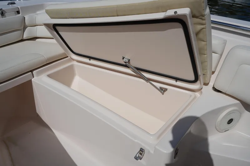 Slide: The Image of 2017 Grady-White Fisherman 236 boat storage compartment with open lid and cushioned seating. - 29