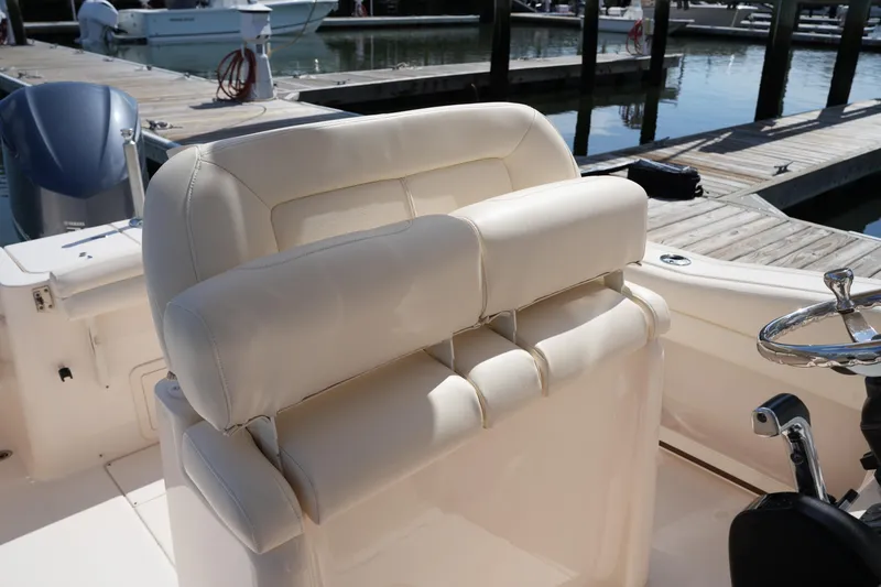 Slide: The Image of 2017 Grady-White Fisherman 236 boat interior with cushioned seating and steering wheel. - 18