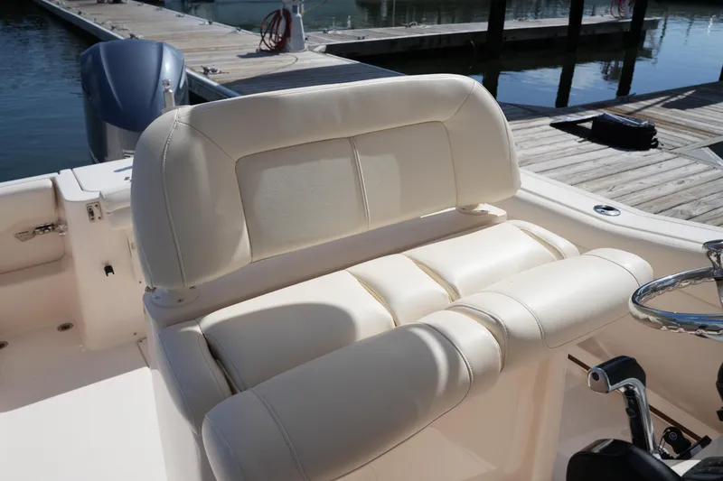 Slide: The Image of 2017 Grady-White Fisherman 236 boat interior with plush seating at dock. - 17