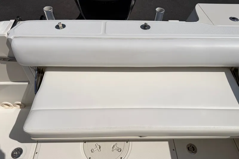 Slide: The Image of 2014 Boston Whaler 220 Outrage boat seat, featuring white cushioned upholstery. - 13