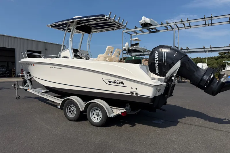 Slide: The Image of 2014 Boston Whaler 220 Outrage boat on trailer with Mercury outboard engine. - 2