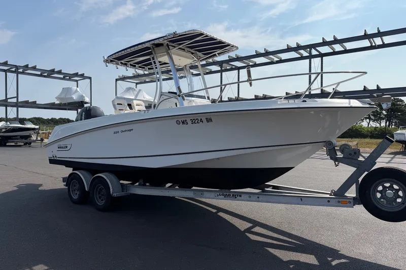 Slide: The Image of 2014 Boston Whaler 220 Outrage boat on trailer in outdoor storage area. - 3