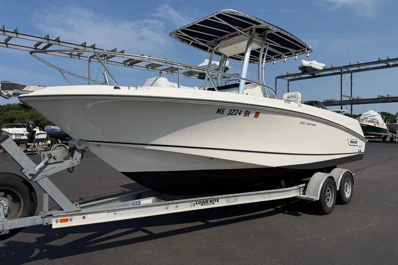 The Image of 2014 Boston Whaler 220 Outrage boat on trailer, ready for transport. - 1