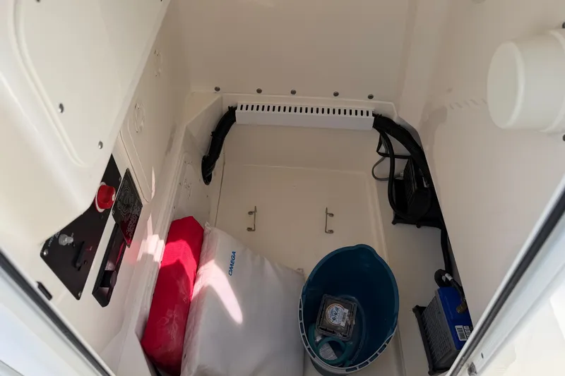 Slide: The Image of Storage compartment of a 2014 Boston Whaler 220 Outrage boat with various items. - 10