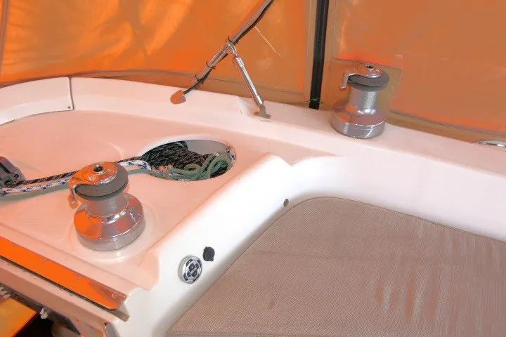 Slide: The Image of Deck of 2001 Hunter 420 sailboat with winches and ropes under orange canopy. - 53