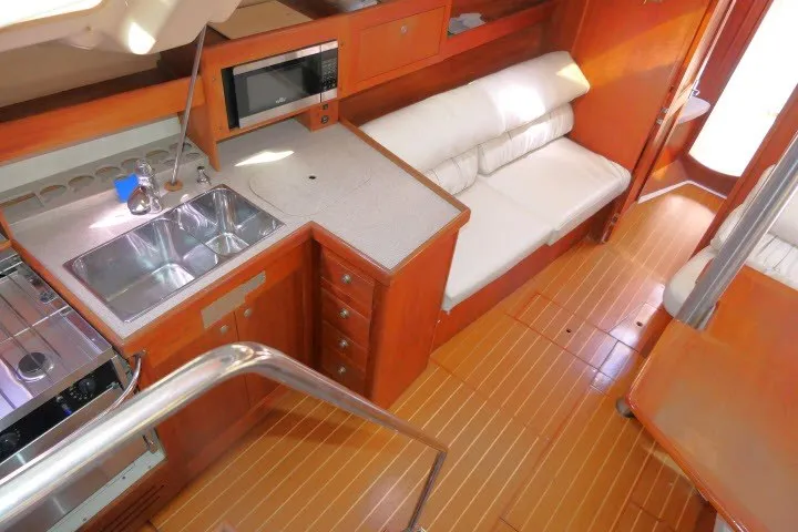 Slide: The Image of Interior of 2001 Hunter 420 yacht with kitchen and seating area. - 5