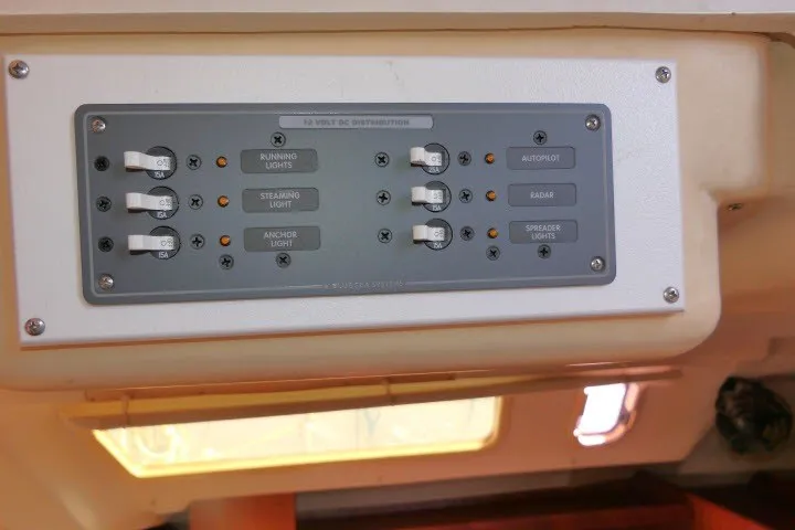 Slide: The Image of Control panel of a 2001 Hunter 420 sailboat with labeled switches for lights and systems. - 85