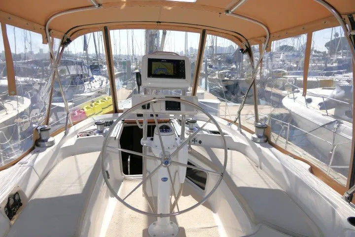 Slide: The Image of Cockpit of a 2001 Hunter 420 sailboat with steering wheel and navigation equipment. - 46