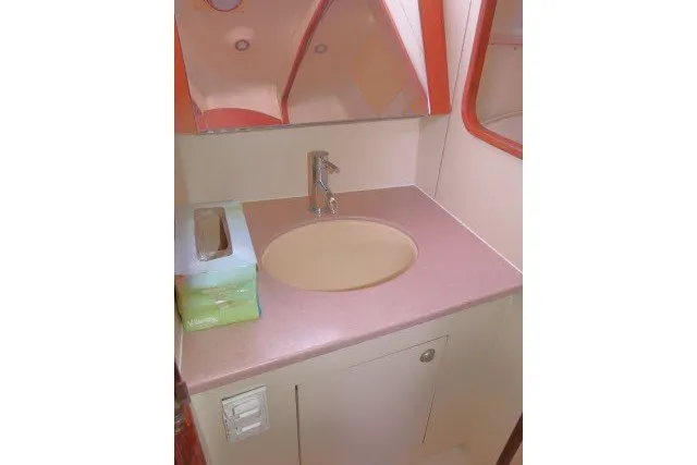 Slide: The Image of 2001 Hunter 420 yacht bathroom sink with mirror and tissue box. - 33