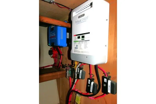 Slide: The Image of Electrical system setup in a 2001 Hunter 420 boat, featuring a ProMariner ProNautic charger. - 81