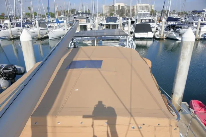Slide: The Image of Sailboat Hunter 420 (2001) docked at marina with covered deck and surrounding yachts. - 68