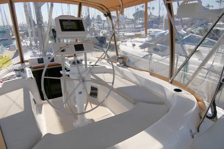 Slide: The Image of Cockpit of a 2001 Hunter 420 sailboat with steering wheel and navigation equipment. - 47