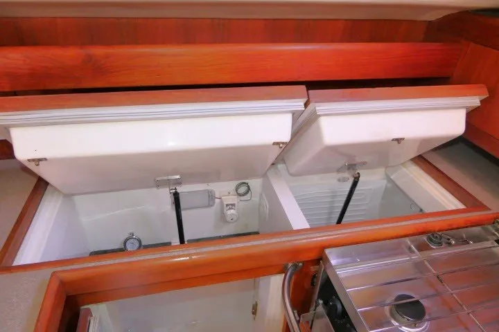 Slide: The Image of Interior view of a 2001 Hunter 420 yacht showing storage compartments. - 14