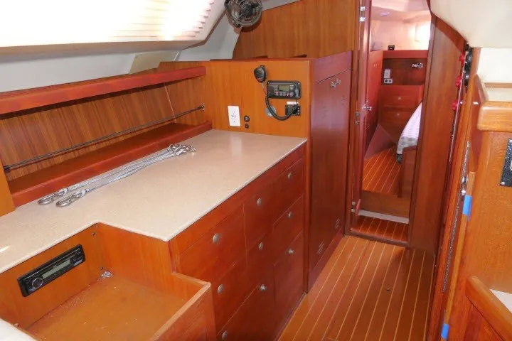 Slide: The Image of Interior of a 2001 Hunter 420 sailboat featuring wooden cabinetry and modern amenities. - 23