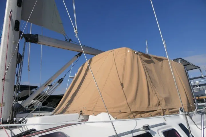 Slide: The Image of Sailboat with tan cover, Hunter 420 model, 2001, docked under clear blue sky. - 63