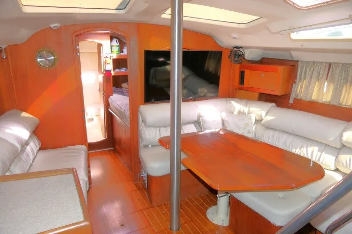 Slide: The Image of Interior of a 2001 Hunter 420 yacht with cozy seating and wooden finishes. - 7