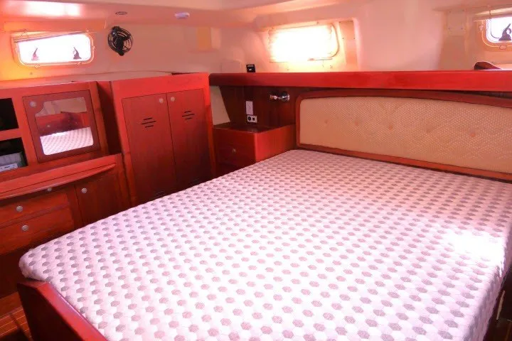Slide: The Image of Luxurious cabin interior of 2001 Hunter 420 yacht with wooden furnishings and cozy bed. - 27