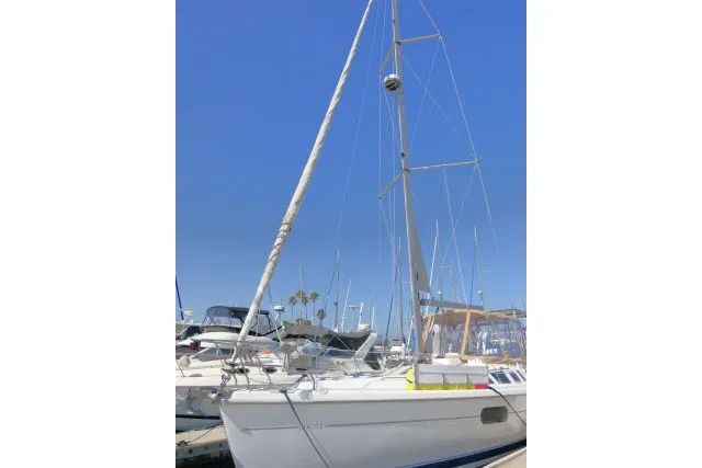 Slide: The Image of Sailboat Hunter 420, 2001 model, docked in a marina under clear blue skies. - 99