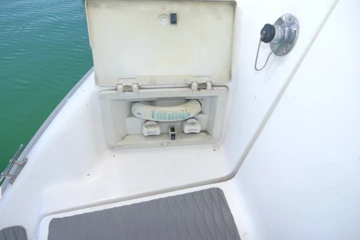 Slide: The Image of 2001 Hunter 420 boat deck with storage compartment and water hose. - 61