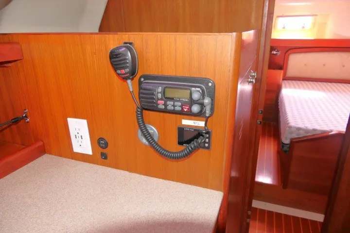 Slide: The Image of Interior of a 2001 Hunter 420 sailboat featuring a radio and cozy cabin. - 24