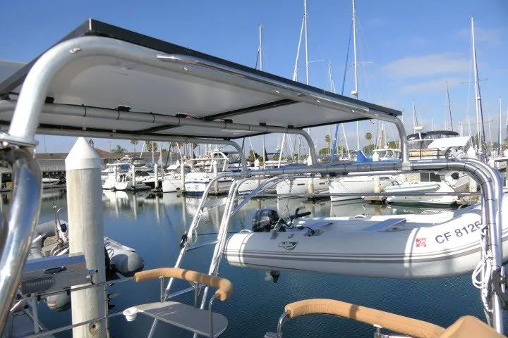 Slide: The Image of Hunter 420 sailboat at marina, featuring a dinghy and solar panels, 2001 model. - 56