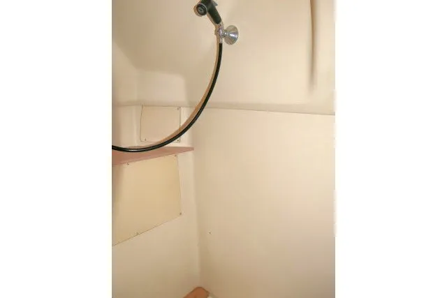 Slide: The Image of Shower area inside a 2001 Hunter 420 sailboat, featuring a handheld showerhead. - 35