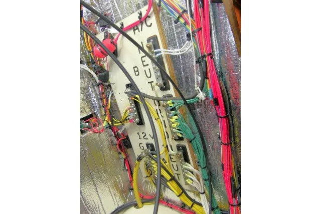Slide: The Image of Electrical wiring panel with colorful cables in a 2001 Hunter 420 model. - 88