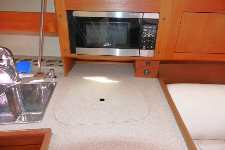 Slide: The Image of Hunter 420 yacht kitchen with sink, microwave, and countertop, 2001 model. - 17