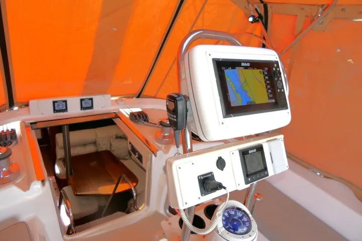Slide: The Image of Cockpit of 2001 Hunter 420 sailboat with navigation equipment and orange canopy. - 40