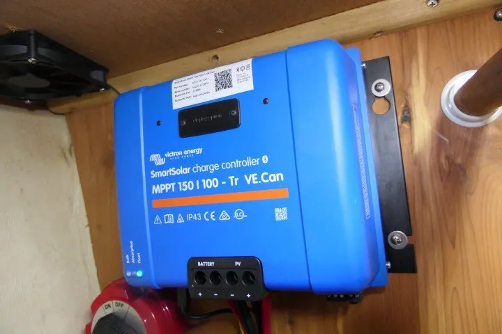 Slide: The Image of Blue Victron Energy SmartSolar charge controller installed on a wooden panel in a Hunter 420, 2001 model. - 83