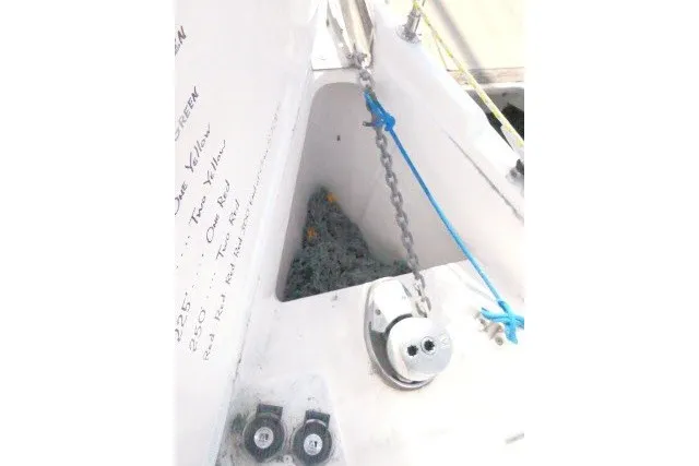 Slide: The Image of Anchor chain and winch on a 2001 Hunter 420 sailboat deck. - 73