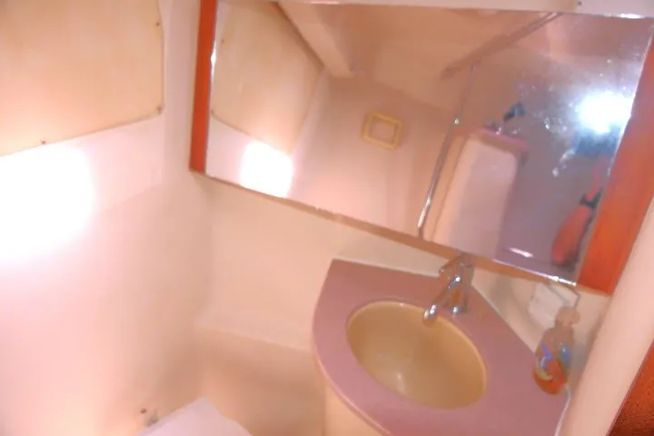 Slide: The Image of 2001 Hunter 420 yacht bathroom with sink, mirror, and faucet. - 22