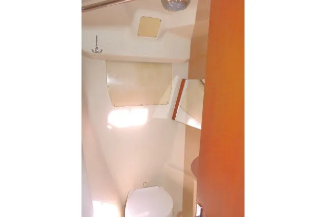 Slide: The Image of 2001 Hunter 420 yacht bathroom interior with toilet, storage, and light wood finish. - 21