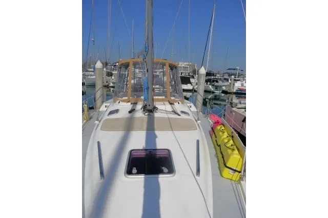 Slide: The Image of 2001 Hunter 420 sailboat docked in a marina under clear blue skies. - 74
