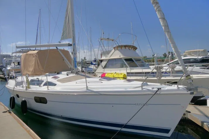 Slide: The Image of 2001 Hunter 420 sailboat docked at marina under clear blue sky. - 102