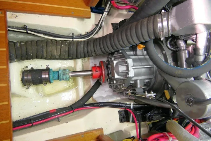 Slide: The Image of Engine compartment of a 2001 Hunter 420 sailboat, showcasing mechanical components and wiring. - 96