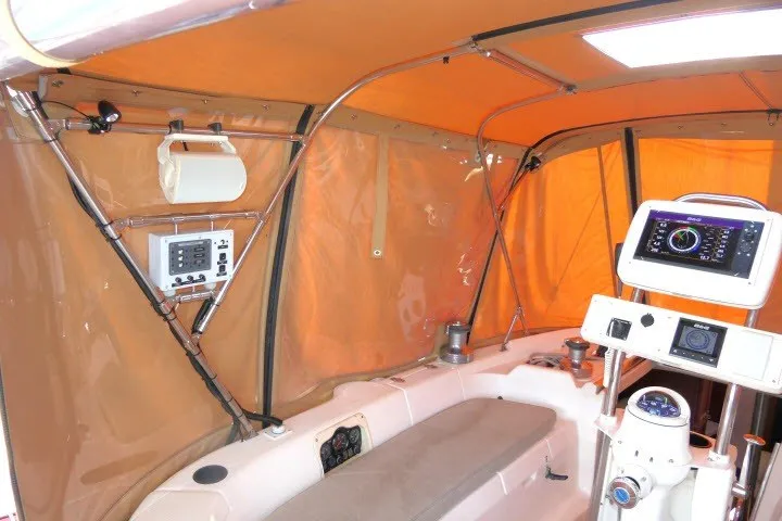 Slide: The Image of Interior of a 2001 Hunter 420 sailboat with navigation equipment and orange canopy. - 42