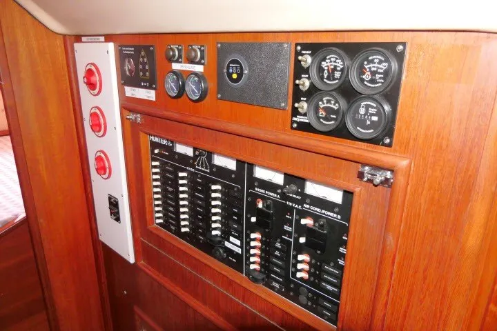 Slide: The Image of Control panel of a 2001 Hunter 420 sailboat with gauges and switches. - 86