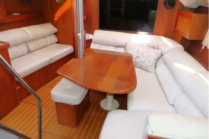 Slide: The Image of Interior of 2001 Hunter 420 yacht with wooden table and white seating. - 4