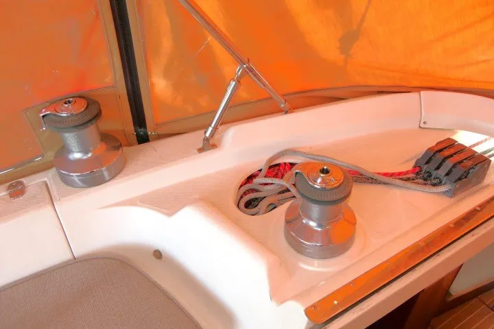 Slide: The Image of Deck of 2001 Hunter 420 sailboat with winches and ropes under orange canopy. - 52