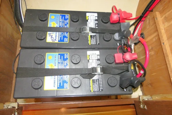 Slide: The Image of Three secured marine batteries with cables in a 2001 Hunter 420 sailboat. - 80