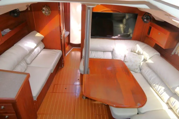 Slide: The Image of Luxurious interior of 2001 Hunter 420 yacht with wooden furnishings and white seating. - 2