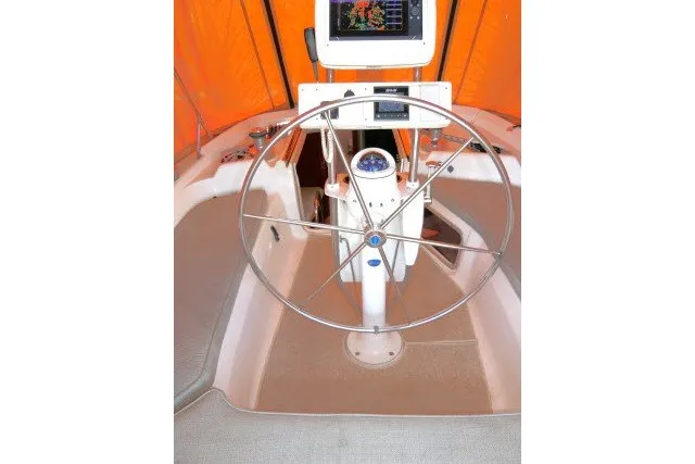 Slide: The Image of Steering wheel of a 2001 Hunter 420 sailboat with navigation equipment. - 38
