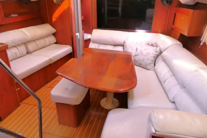 Slide: The Image of Luxurious interior of 2001 Hunter 420 yacht with plush seating and wooden table. - 3