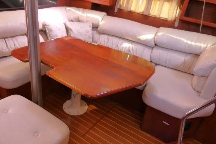 Slide: The Image of Interior of 2001 Hunter 420 yacht with wooden table and cushioned seating. - 10