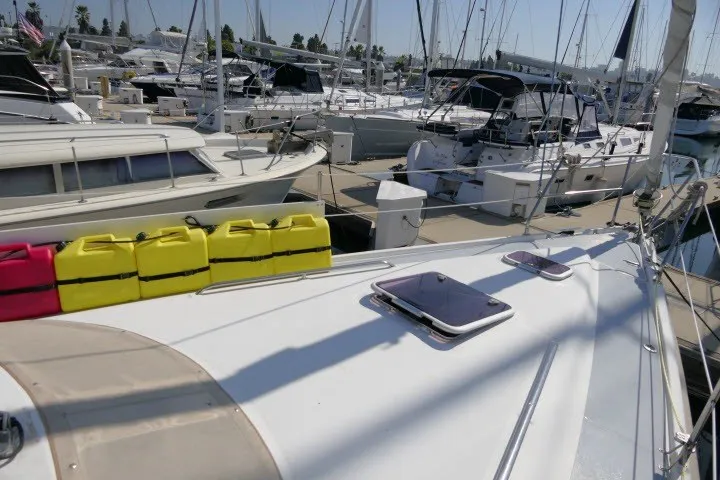 Slide: The Image of Sailboats docked at a marina, featuring a 2001 Hunter 420 model in the foreground. - 71